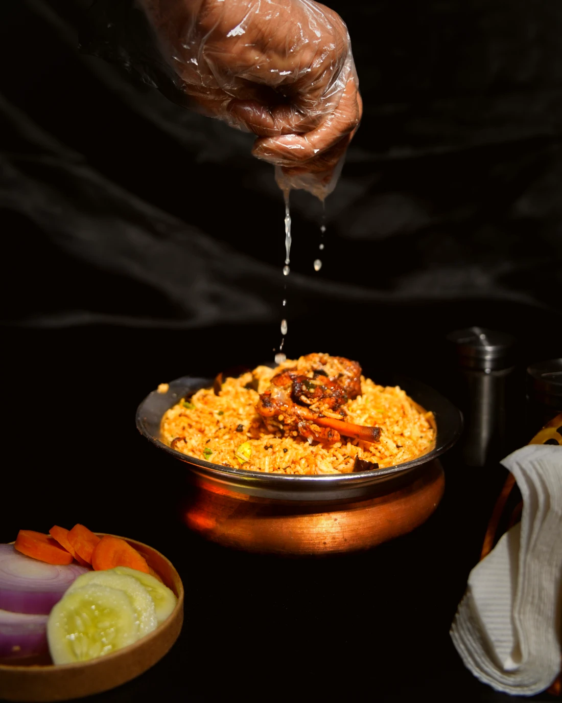 Biryani plated with raita and salan
