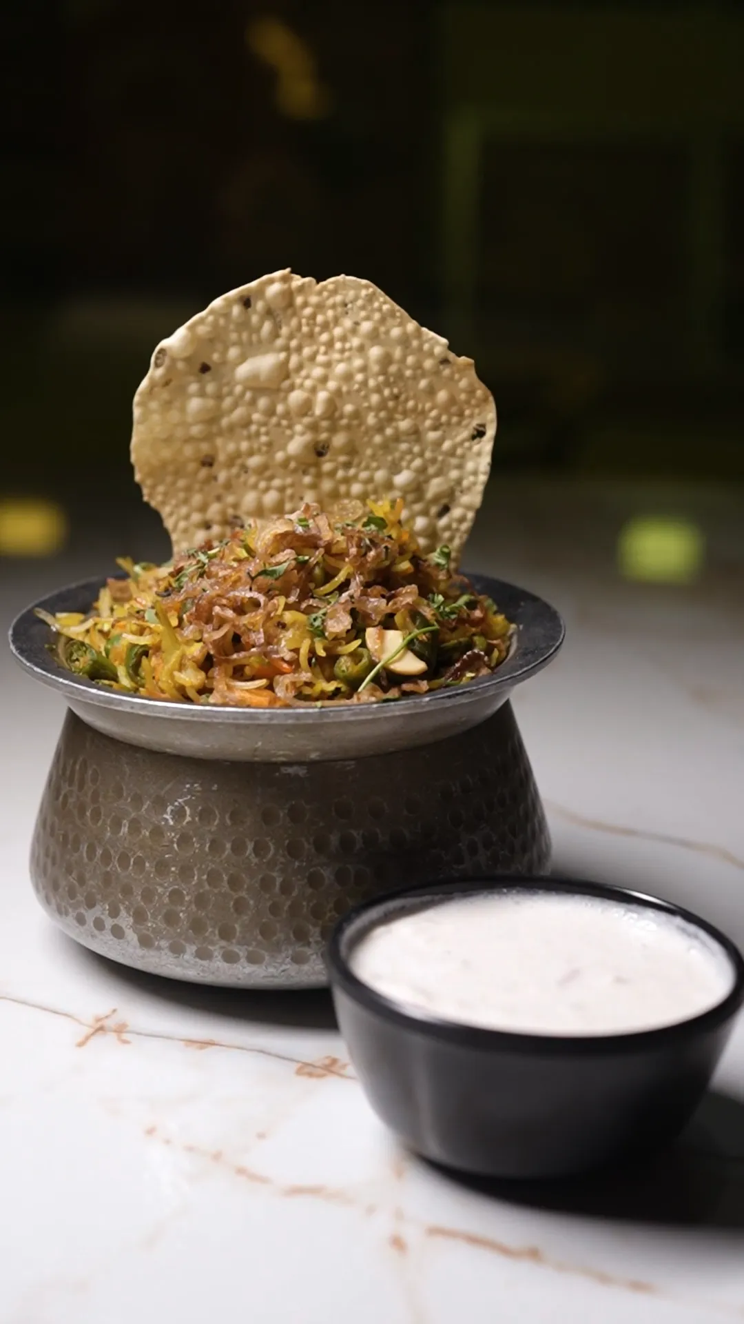 Biryani being plated from a serving dish